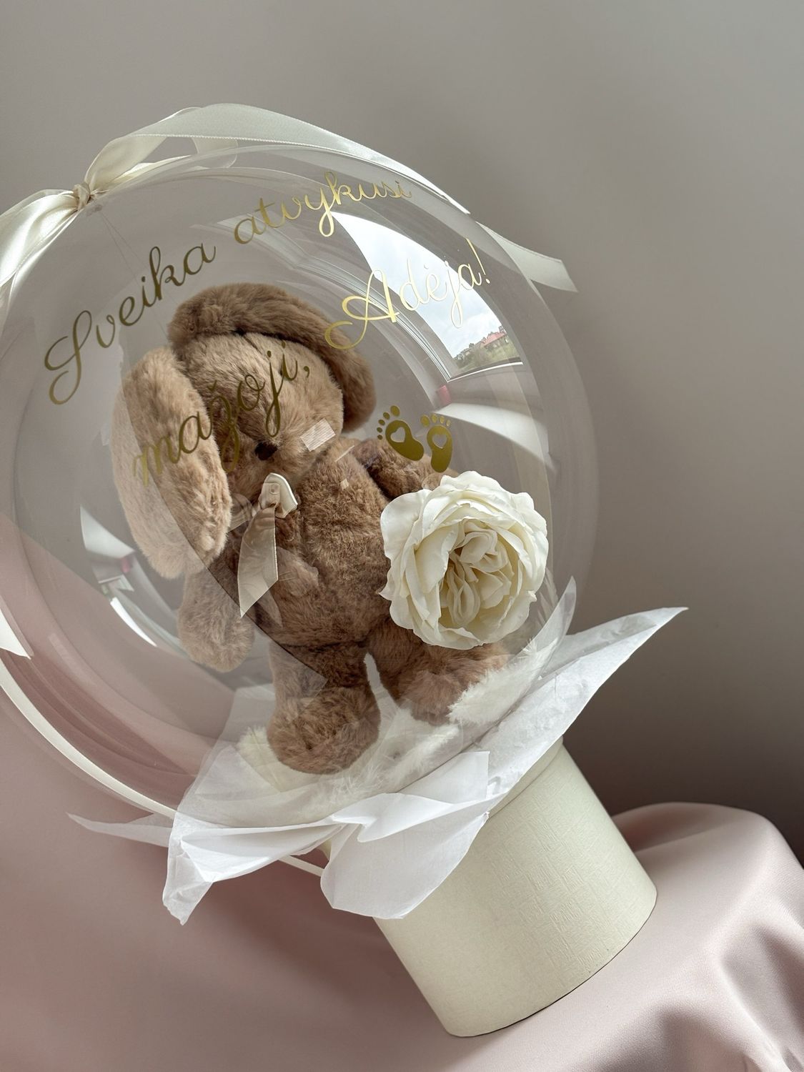 A teddy bear in a newborn balloon gift